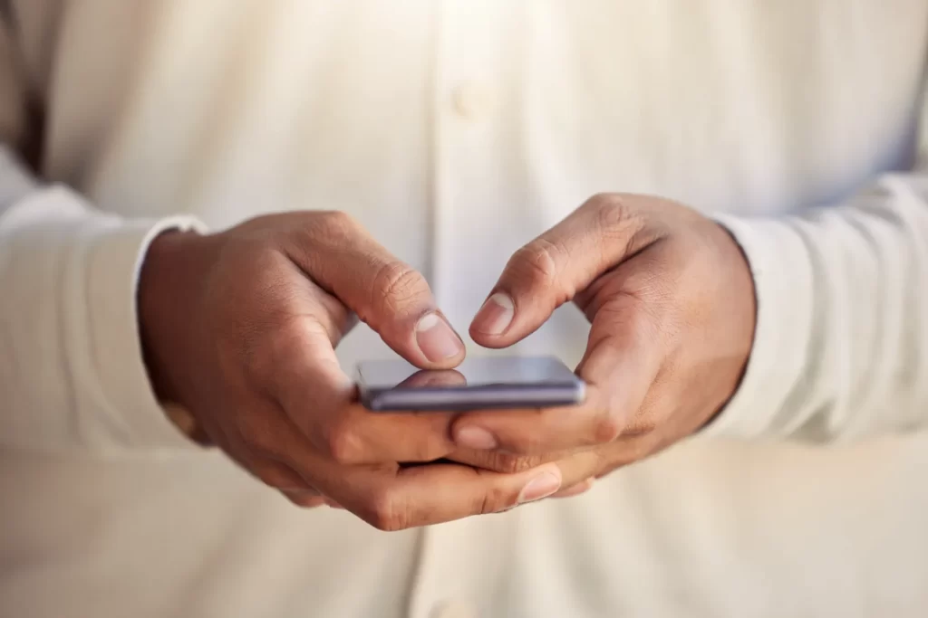close up of hands using mobile phone utc ()